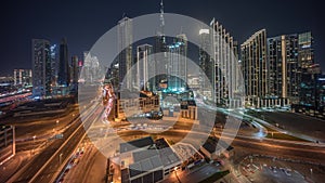 Aerial view of Dubai Downtown skyline with many towers night timelapse.