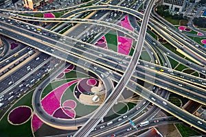 Aerial view of Dubai highways at sunset, modern urban architecture and traffic background, United Arab Emirates