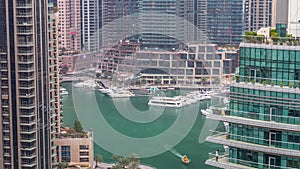 Aerial view of Dubai Marina residential and office skyscrapers with waterfront day to night timelapse