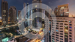 Aerial view of Dubai Marina residential and office skyscrapers with waterfront night to day timelapse