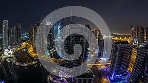 Aerial view of Dubai Marina residential and office skyscrapers with waterfront night to day timelapse