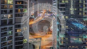 Aerial view on Dubai Marina skyscrapers and the most luxury yacht in harbor night timelapse, Dubai, United Arab Emirates