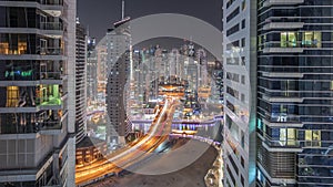 Aerial view on Dubai Marina skyscrapers and the most luxury yacht in harbor night timelapse, Dubai, United Arab Emirates