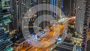 Aerial view on Dubai Marina skyscrapers and the most luxury yacht in harbor night timelapse, Dubai, United Arab Emirates