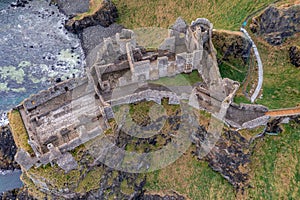 Aerial view with Dunluce Castle, the famous fortress in ruin in Northern Ireland UK, seen at sunrise