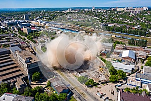 Aerial view of dust cloud after collapsing of old building after demolishing in Kharkiv