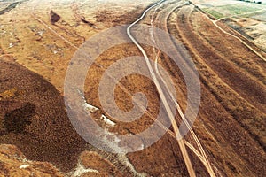 Aerial view of dusty dirt road in plain landscape