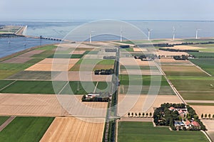 Aerial view Dutch agricultural landscape with wind turbines along coast