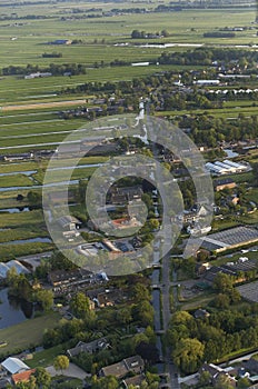 Aerial view of dutch farmland village along rural road