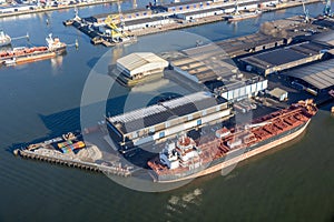 Aerial view Dutch industrial park with harbors and ships