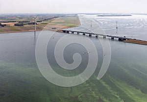 Aerial view Dutch landscape with bridge, wind turbine and algae