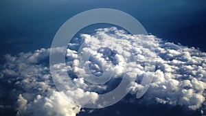 Aerial view of the earth cover by clouds. Background of blue sky with cloud and the ocean scenery from the airplane.