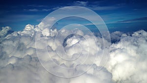 Aerial view of the earth cover by clouds. Background of blue sky with cloud and the ocean scenery from the airplane. Natural