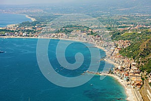 Aerial view of Eastern Sicily coast with blue sea. Beautiful Italy coastline