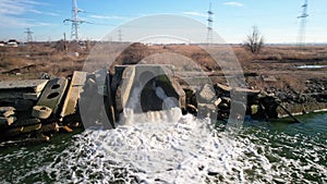 Aerial view. Ecology of fresh water, the stream of dirty water from the treatment plant discharges into a reservoir, Drone shot