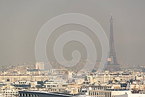 Aerial view of the Eiffel tower in the fog in Paris.