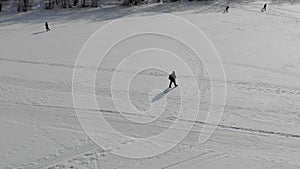 Aerial view an elderly woman engaged in Nordic walking with sticks in the winter forest. Healthy lifestyle concept
