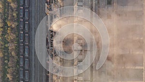 Aerial view. Emission to atmosphere from industrial pipes. Smokestack pipes shooted with drone. Close-up.