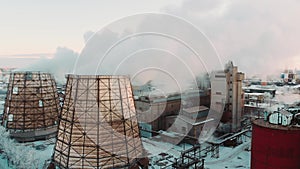 Aerial view. Emission to atmosphere from industrial pipes. Smokestack pipes shooted with drone. Close-up.