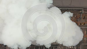 Aerial view. Emission to atmosphere from industrial pipes. Smokestack pipes shooted with drone. Close-up.