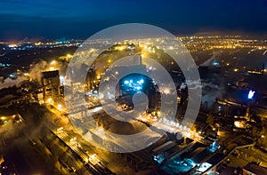 Aerial view. Emission to atmosphere from industrial pipes. Smokestack pipes shooted with drone. Night scene