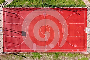Aerial view of empty basketball play ground with green grass around