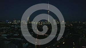 AERIAL: View of empty Berlin, Germany City Scape Skyline at Night with City Light During COVID19 Corona Virus Pandemic