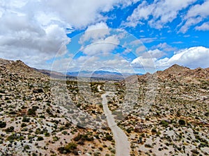 Aerial view of empty dirt road in the arid desert.