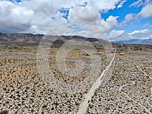 Aerial view of empty dirt road in the arid desert.