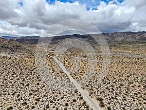 Aerial view of empty dirt road in the arid desert.