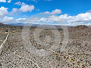 Aerial view of empty dirt road in the arid desert.