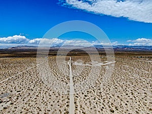 Aerial view of empty dirt road in the arid desert.