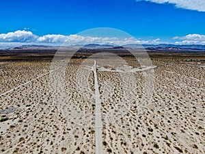 Aerial view of empty dirt road in the arid desert.