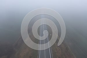Aerial view of a empty highway passing through agricultural fields