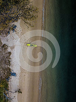 Aerial view of an empty kayak shoreside on a sandy beach