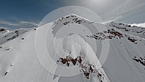 Aerial view empty mountain snowy freeze winter panorama picturesque sunny summit cliff ridge