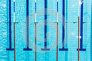Aerial view of an empty swimming pool with five lanes divided with lane ropes