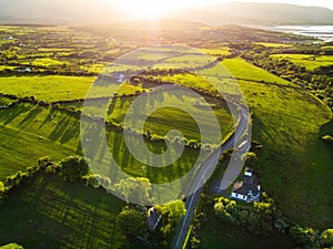 Aerial view of endless lush pastures and farmlands of Ireland. Beautiful Irish countryside with emerald green fields and meadows.