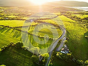 Aerial view of endless lush pastures and farmlands of Ireland. Beautiful Irish countryside with green fields and meadows. Rural