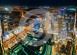 Aerial view of evening night illuminations scenic view of skyscraper in Dubai. Street night traffic in Dudai skyline