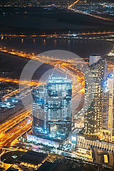 Aerial view of evening night illuminations scenic view of skyscraper in Dubai. Street night traffic in Dudai skyline