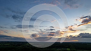 Aerial view of an evening sky over the fields overcast with thunder storm clouds coming in on the sunrise or sunset