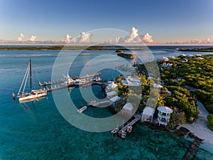 Aerial view of exotic island with authentic buildings and pier for yachts