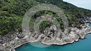 Aerial view on exotic tropical island washed by the blue sea. Jungle paradise for romantic vacation. Sunny day and calm