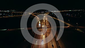 Aerial view of an expressway with little car traffic at night.