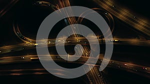 Aerial view of an expressway with little car traffic at night.