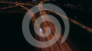 Aerial view of an expressway with little car traffic at night.