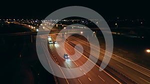 Aerial view of an expressway with little car traffic at night.