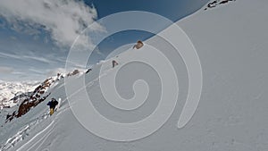 Aerial view extreme sports people climbing on high snowy mountain summit riding snowboard ski tour