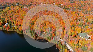 Aerial view of fall season foliage colors and lake houses